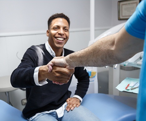 Man at dental office shaking hands with Spring, Texas dentist