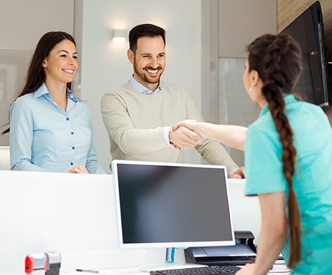 Man and woman checking in at dental office