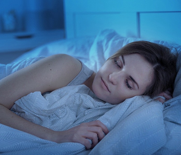 Woman sleeping soundly thanks to sleep apnea oral appliance