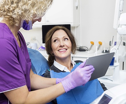 dentist showing a patient a tablet