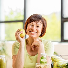 happy woman holding an apple 