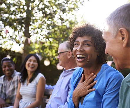 group of people laughing together outside