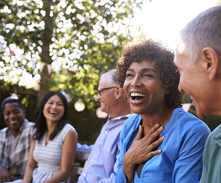 group of people laughing together outside 