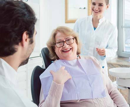 Patient talking to dentist in Spring about dentures
