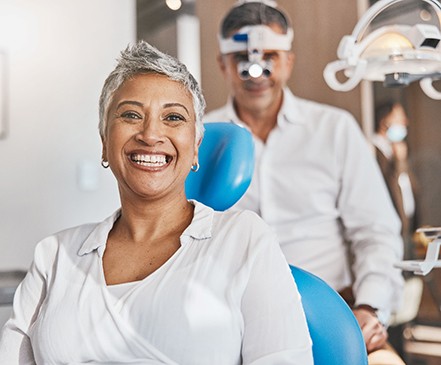 Woman smiling while sitting in dentist's treatment chair