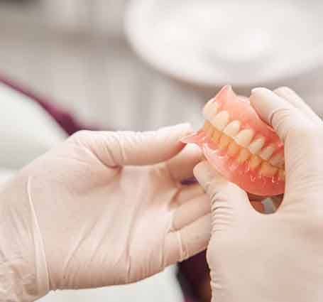 a dental technician creating dentures