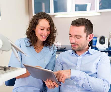 Man learning cost of treating dental emergencies