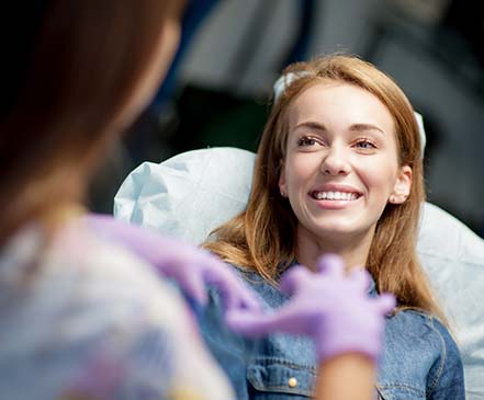 Patient learning how to prevent dental emergencies from dentist