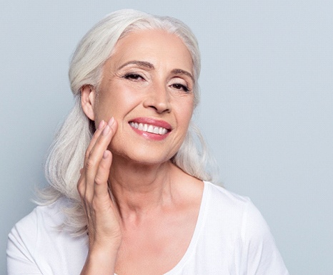 woman with implant supported denture smiling