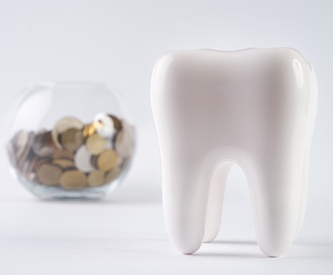 Tooth and jar of change demonstrating dental insurance savings