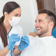 Patient and dentist discussing the cost of Invisalign in Spring