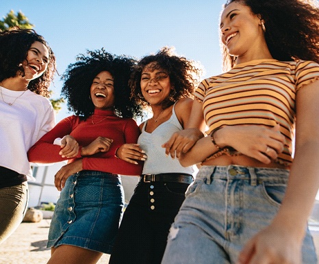 friends laughing together straight smiles thanks to Invisalign clear braces