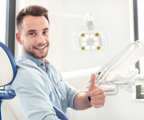 dental patient giving a thumbs up