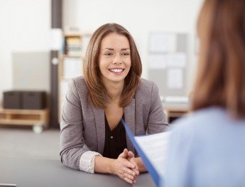 patient smiling at receptionist in Spring