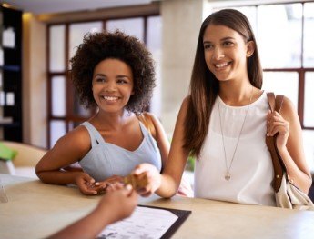 patients smiling at receptionist desk in Spring
