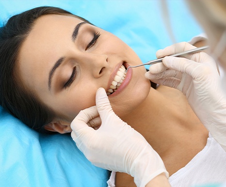 Woman receiving scaling and root planing treatment