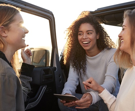 friends talking to each other beautiful smile thanks to porcelain veneers