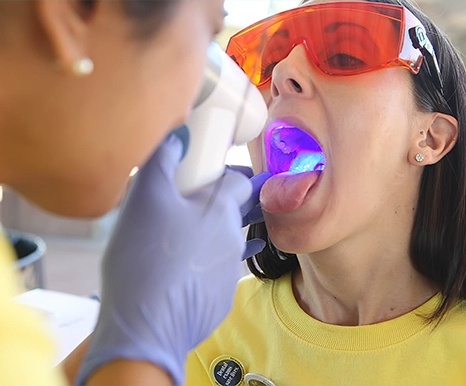 Dentist performing oral cancer screening