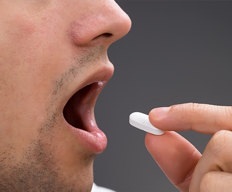 Man taking oral conscious sedation dentistry pill