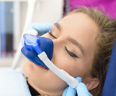 Woman with nitrous oxide dental sedation mask