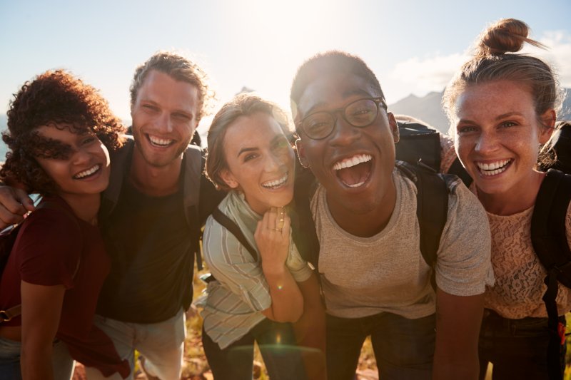 group of friends with beautiful smiles thanks to cosmetic dentist in Spring