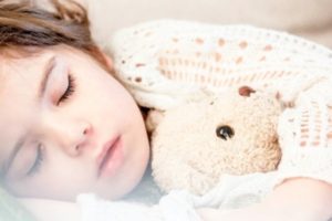 Young girl fast asleep after receiving sleep apnea treatment.