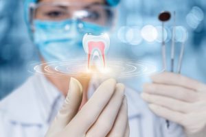 a cosmetic dentist holding a graphic illustration of a tooth