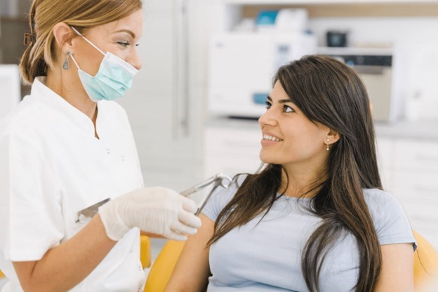 dentist talking to patient about kinds of dental crowns 