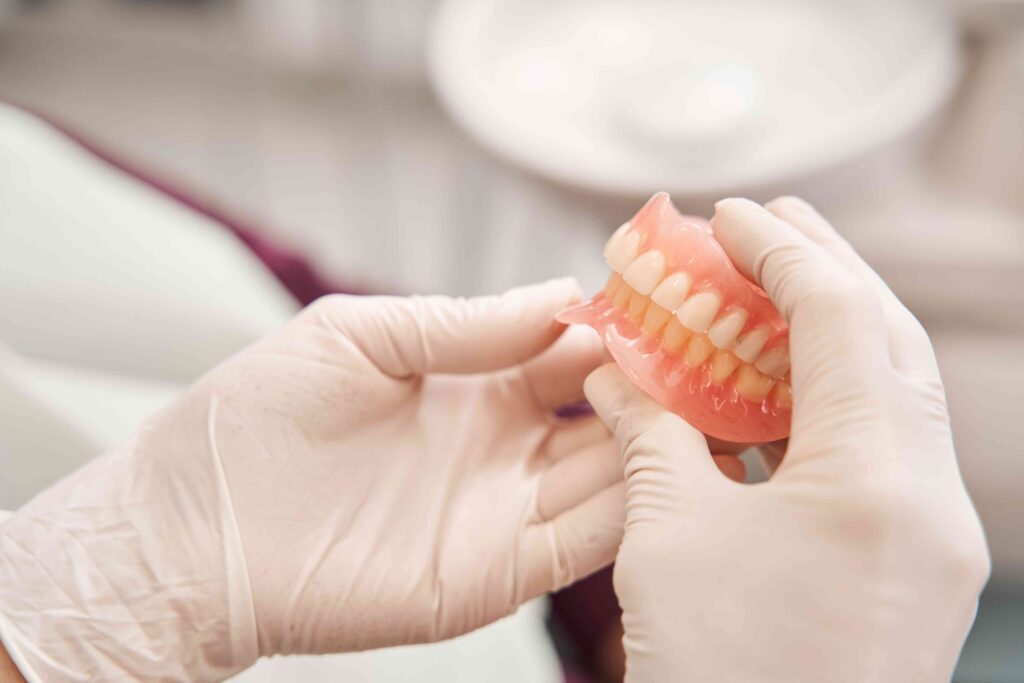 Dentist holding dentures